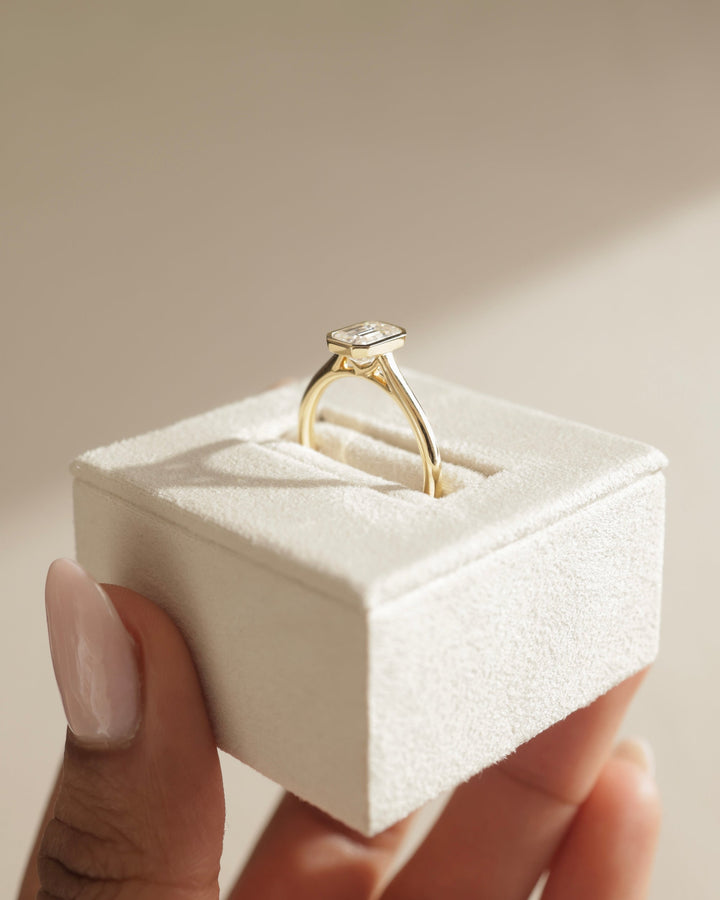 Emerald cut bezel engagement ring shown in real-life wear