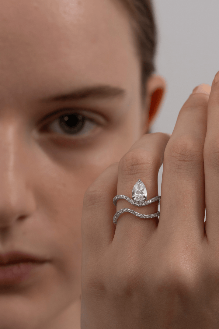 Macro shot of pear cut diamond facets in solitaire ring setting