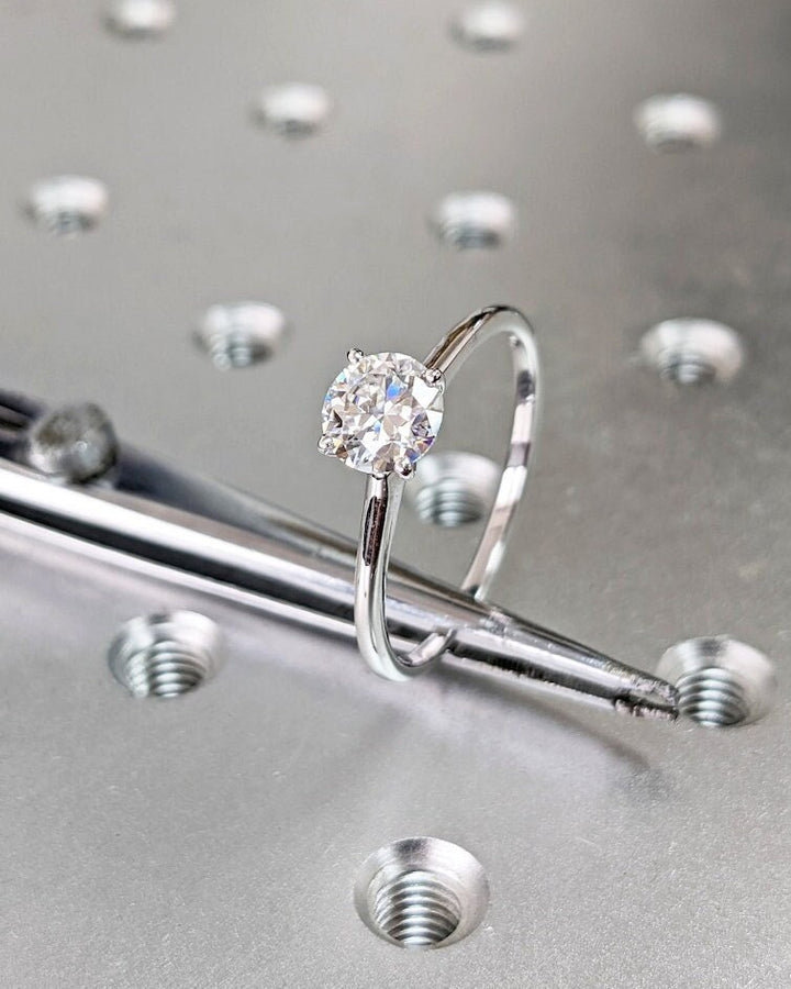 Profile view of round cut solitaire engagement ring band