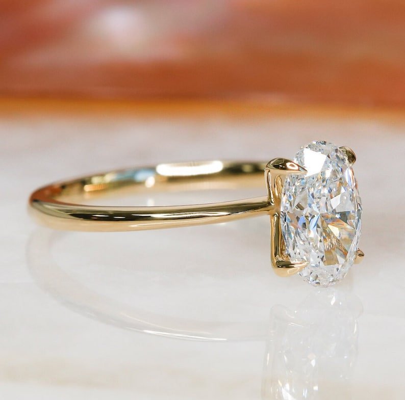 Detailed close-up of oval solitaire diamond engagement ring