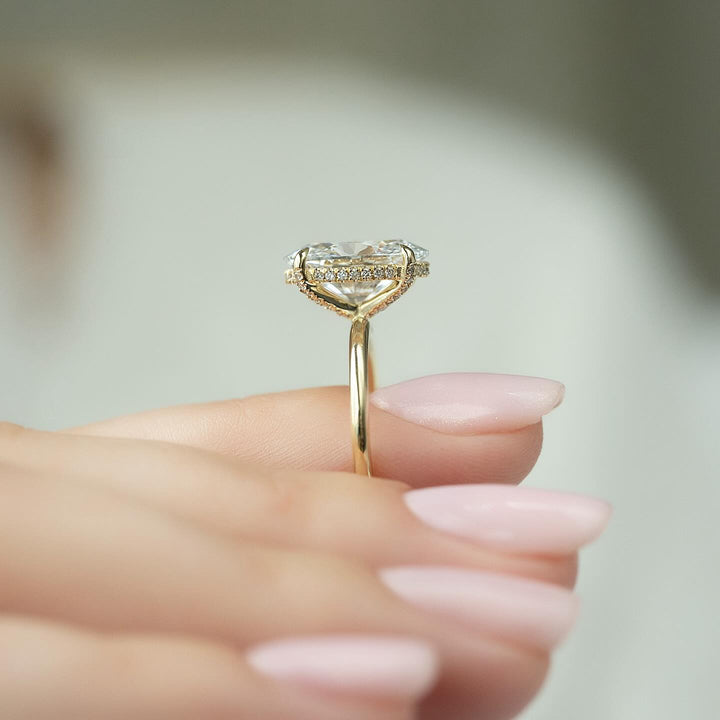 Oval hidden halo ring set with an IGI graded diamond