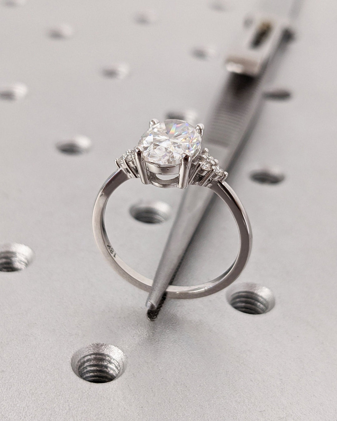 Profile view of oval cut cluster engagement ring band