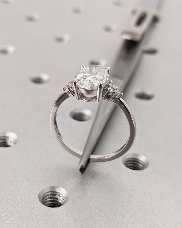 Profile view of oval cut cluster engagement ring band