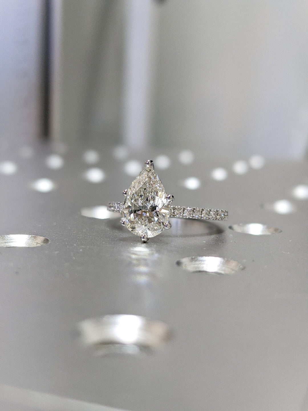 Pear cut pave engagement ring shown in real-life wear