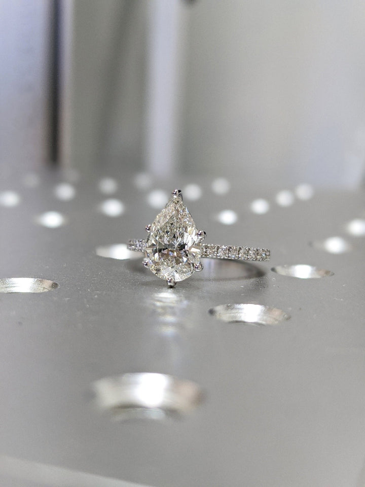 Pear cut pave engagement ring shown in real-life wear