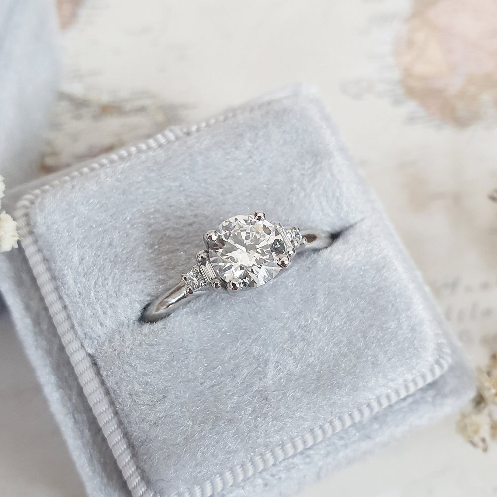 Profile view of round cut five stone engagement ring band