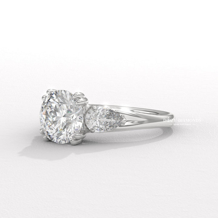 Round three stone engagement ring shown on hand for true-to-life sizing
