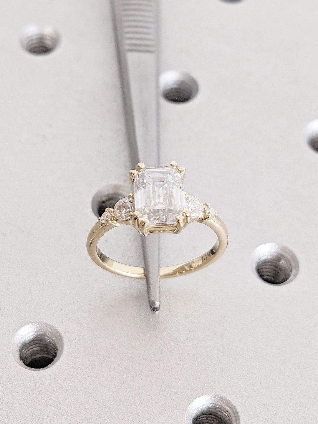 Emerald cluster diamond ring presented in signature gift packaging