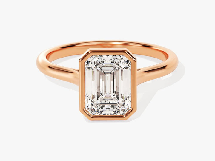 Emerald bezel engagement ring close-up highlighting diamond sparkle
