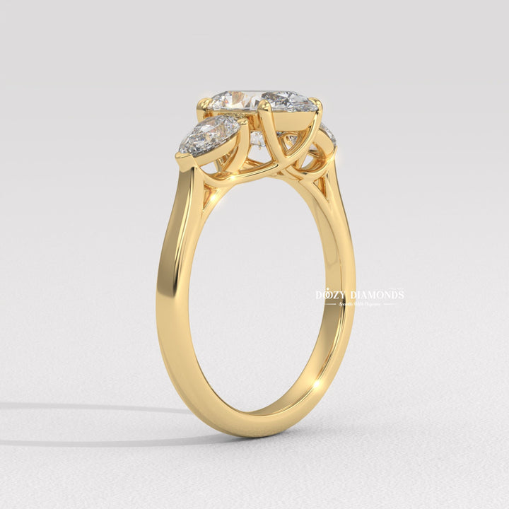 Close-up of oval cut center diamond in three stone engagement ring