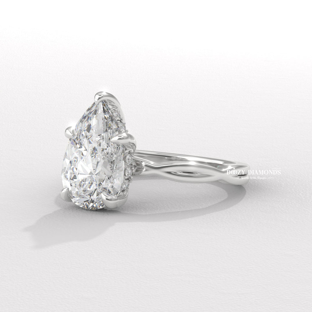 Lifestyle shot of pear solitaire diamond ring on hand