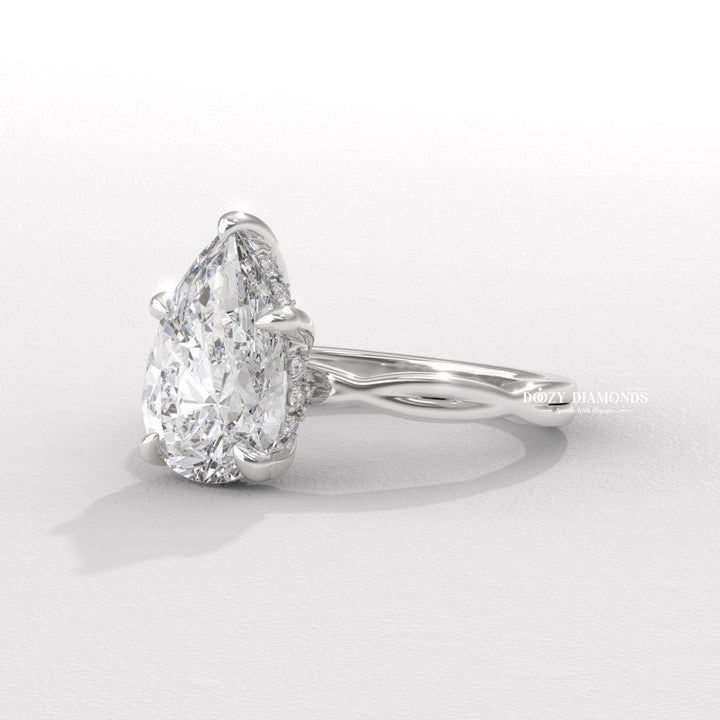 Lifestyle shot of pear solitaire diamond ring on hand