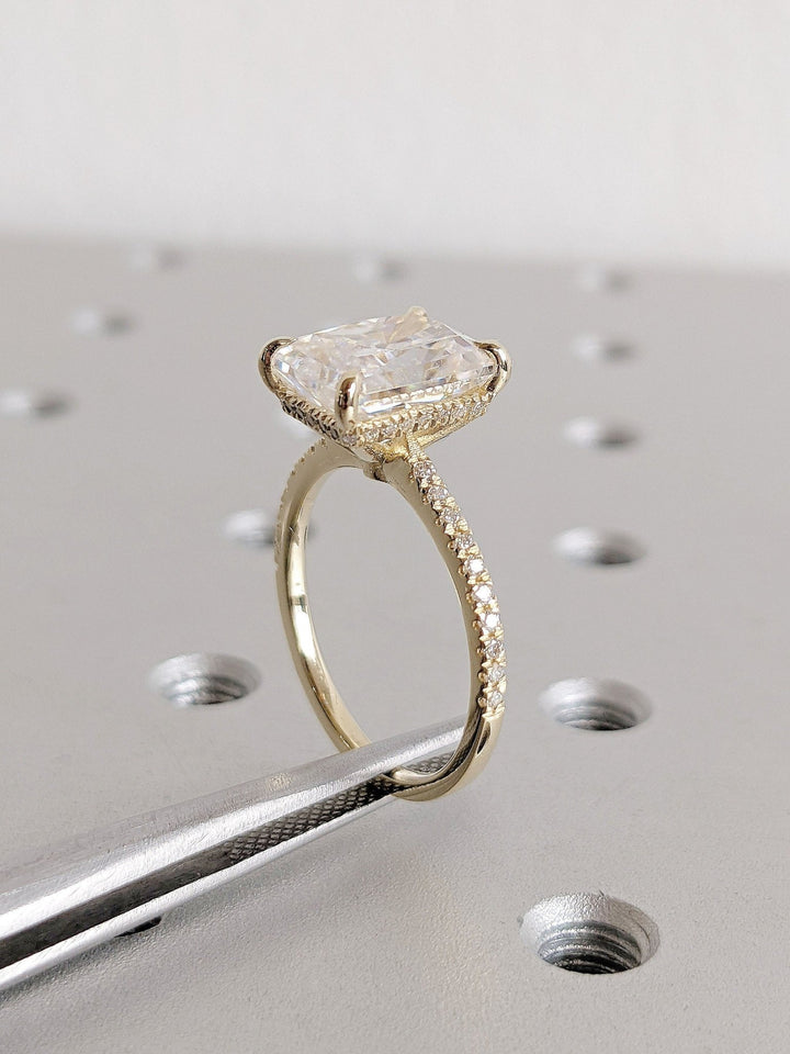 Lifestyle shot of radiant hidden halo diamond ring on hand