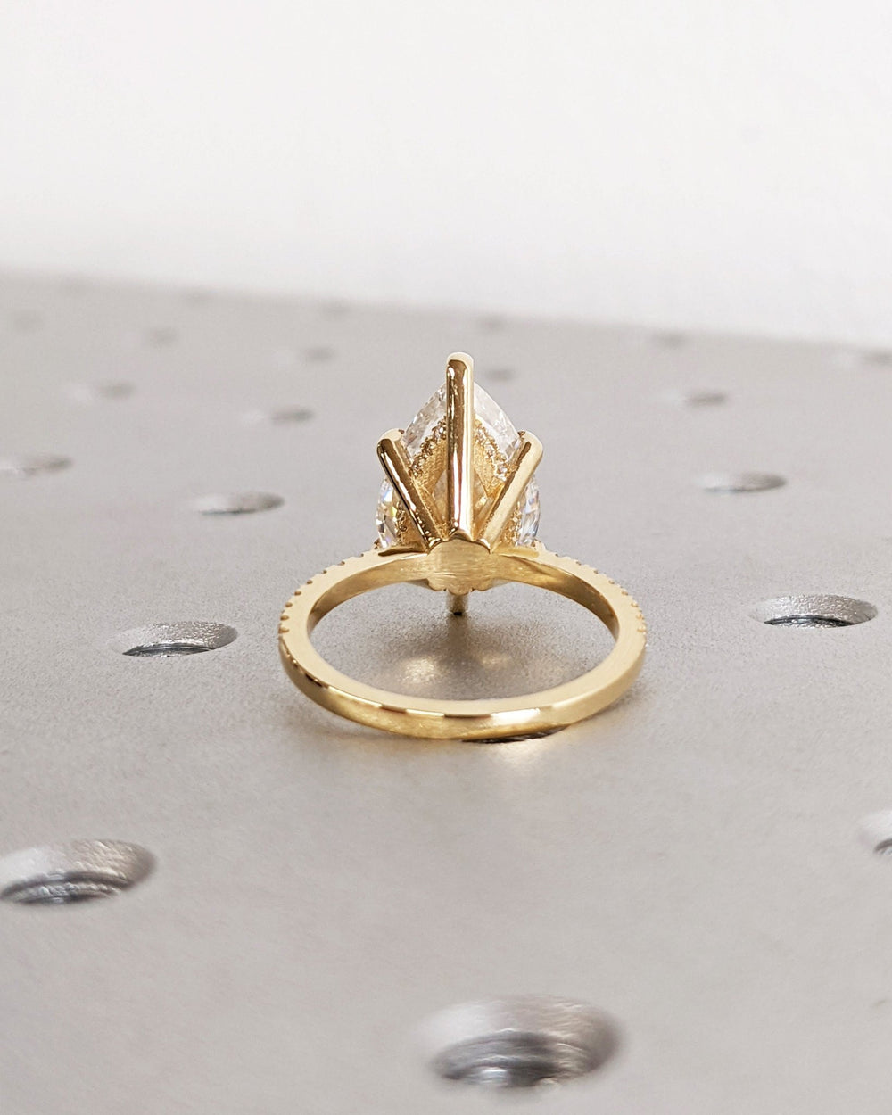 Premium pear cut hidden halo engagement ring crafted in solid gold