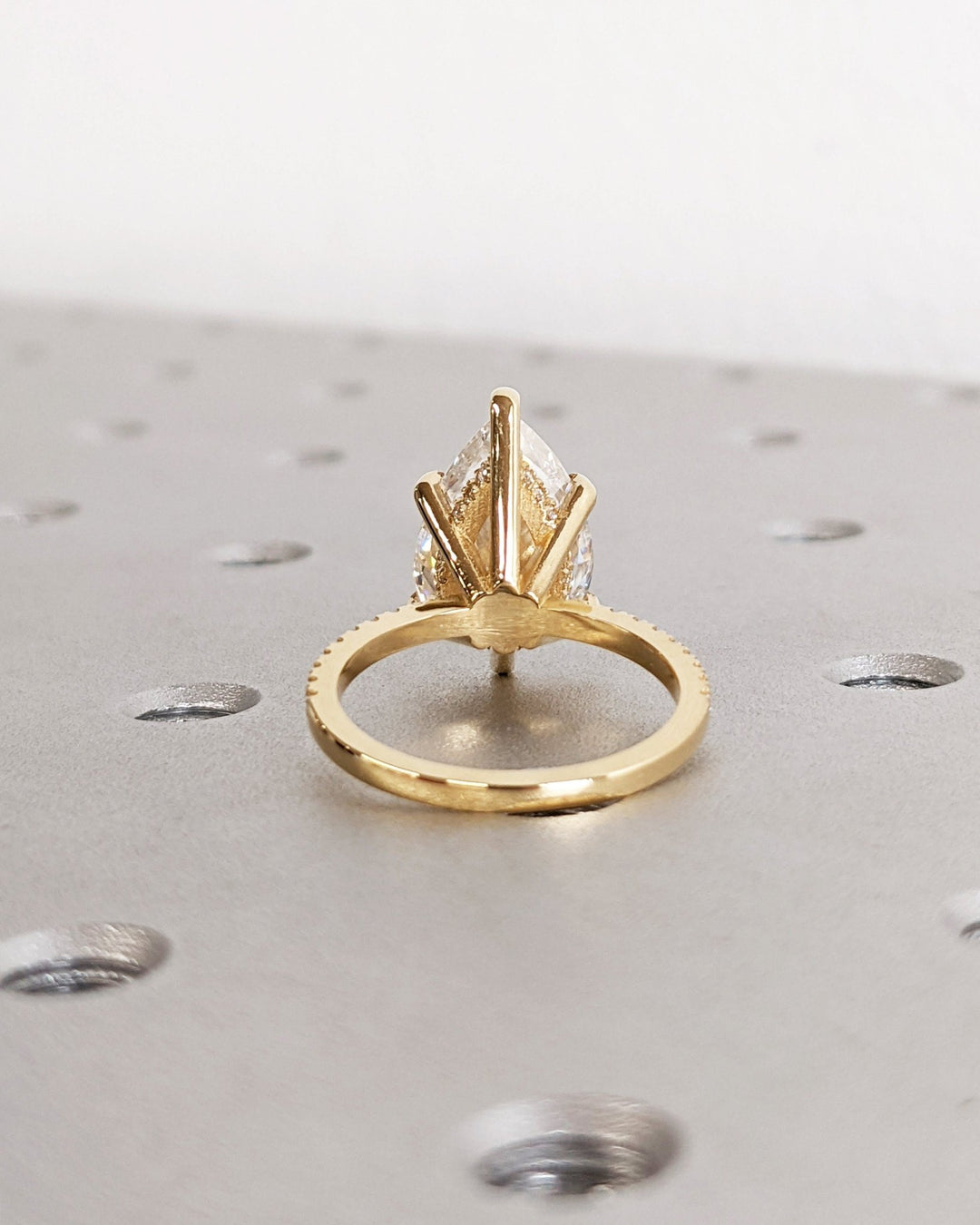 Premium pear cut hidden halo engagement ring crafted in solid gold