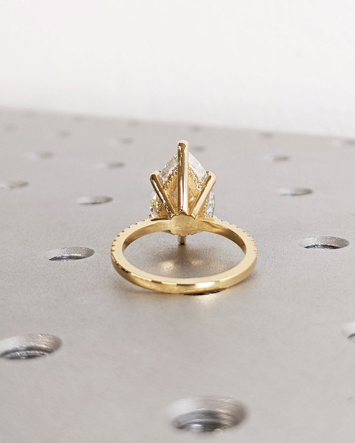 Premium pear cut hidden halo engagement ring crafted in solid gold