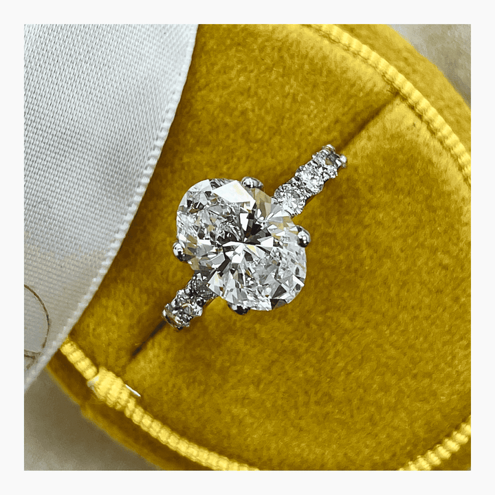 Oval pave ring set with an IGI graded diamond