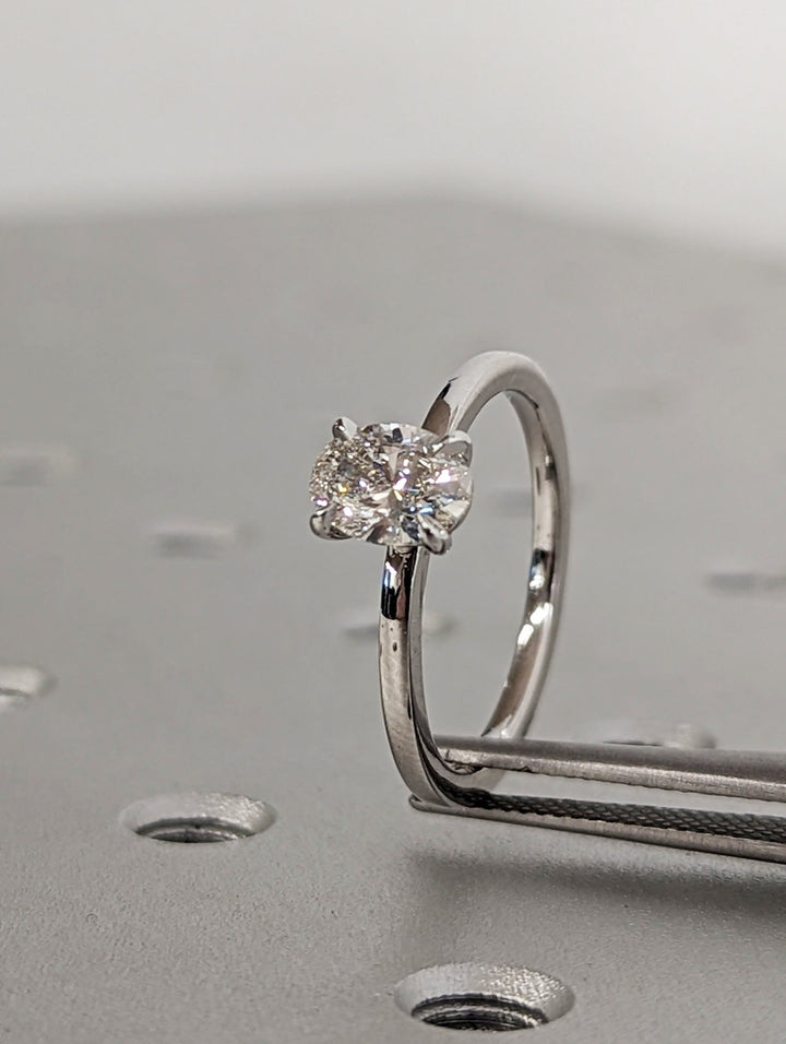 Oval solitaire engagement ring close-up highlighting diamond sparkle