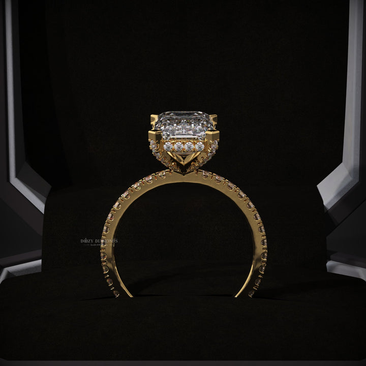 Emerald hidden halo engagement ring photographed in natural light