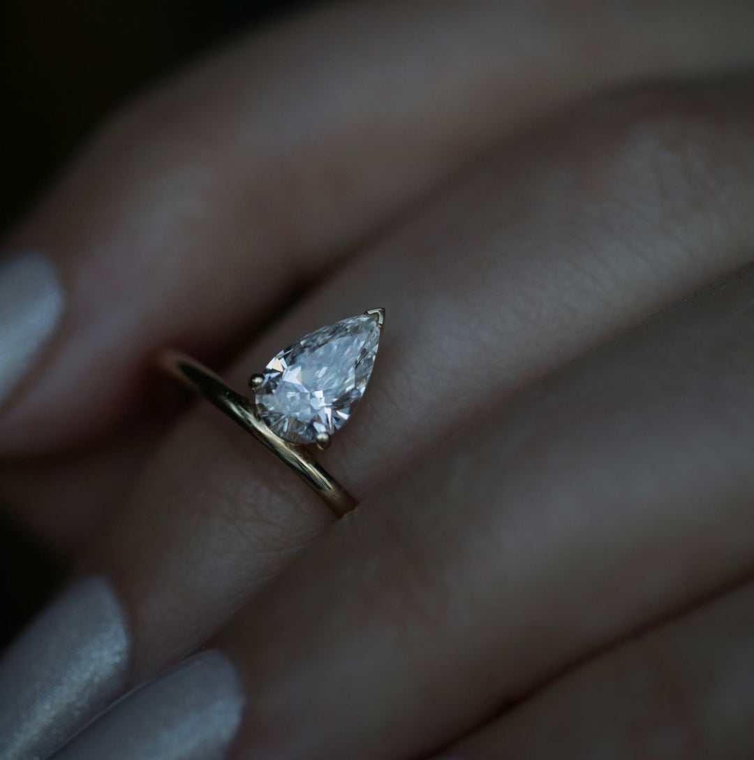 Pear solitaire engagement ring photographed in natural light
