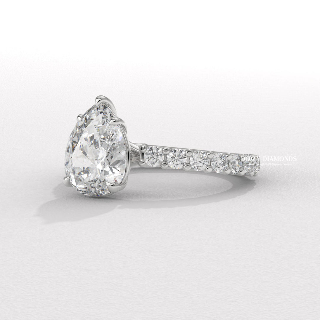 Pear solitaire engagement ring close-up highlighting diamond sparkle