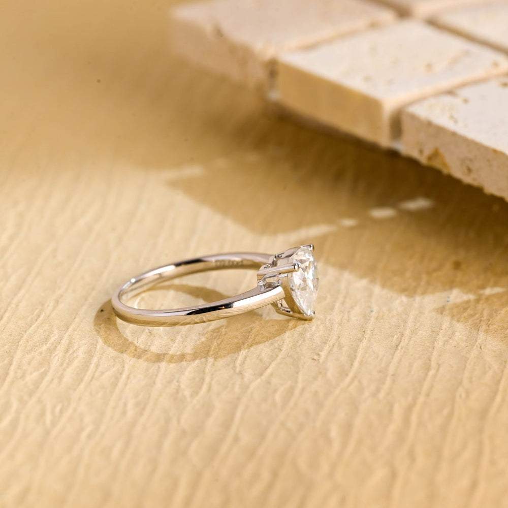 Heart solitaire ring set with an IGI graded diamond