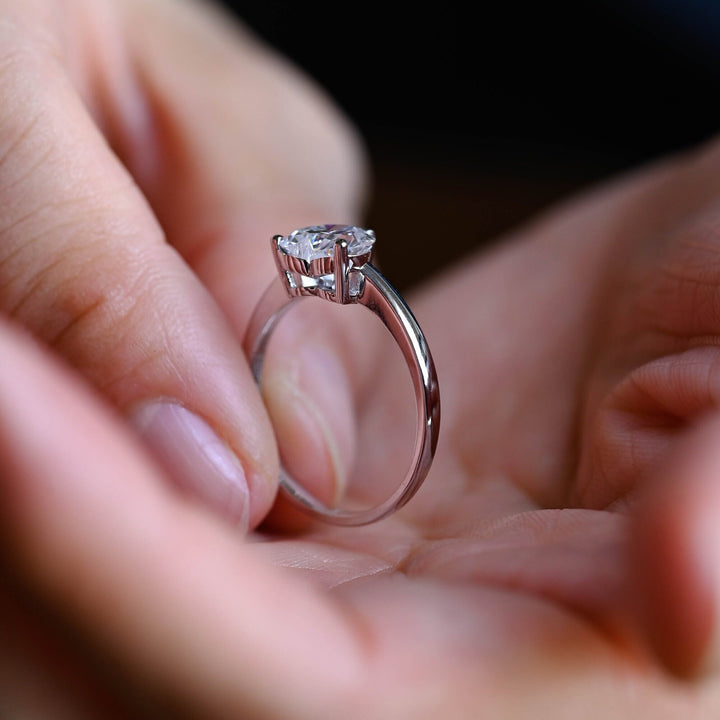 Heart cut engagement ring shown with authenticity certificate