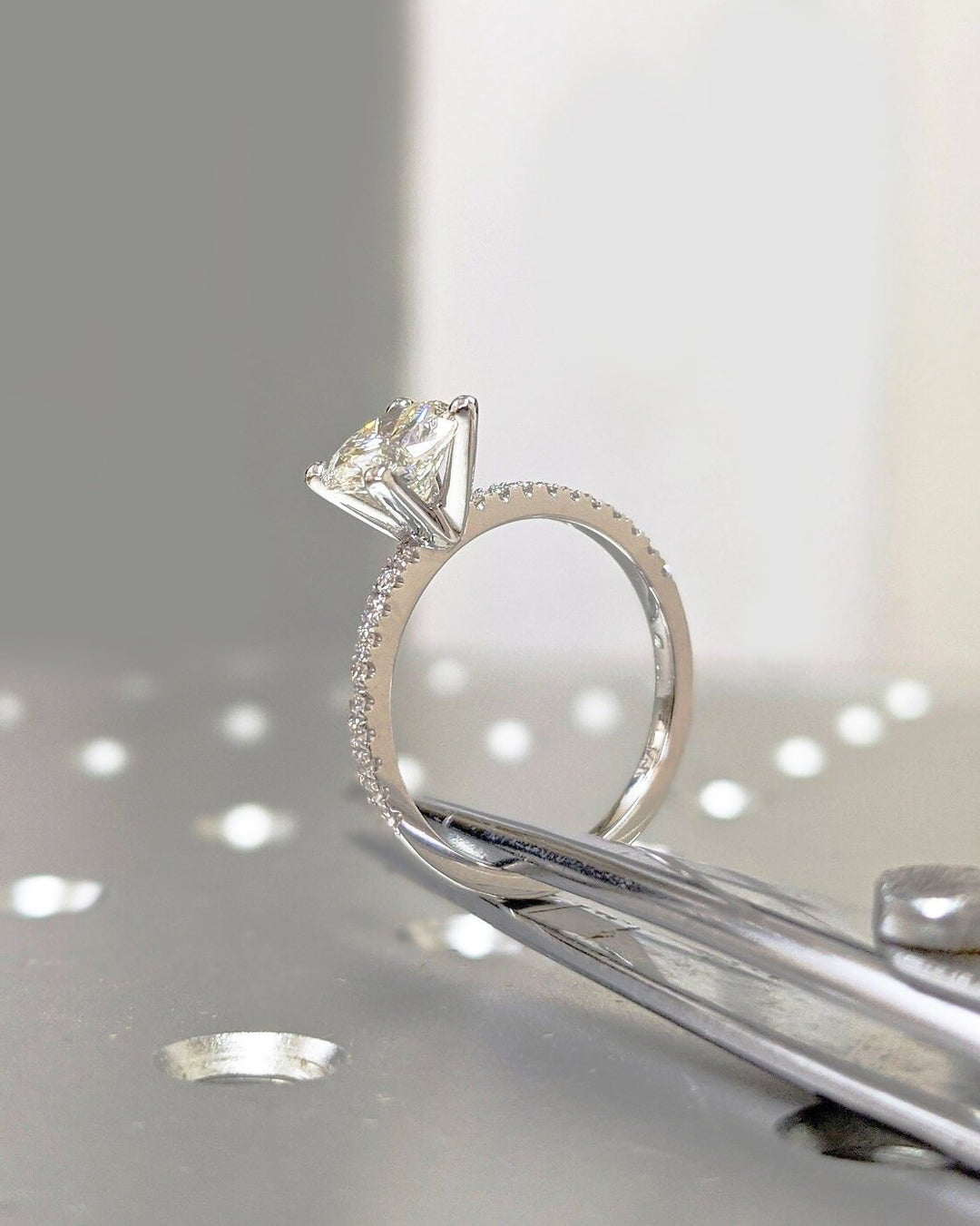 Round pave engagement ring photographed in natural light