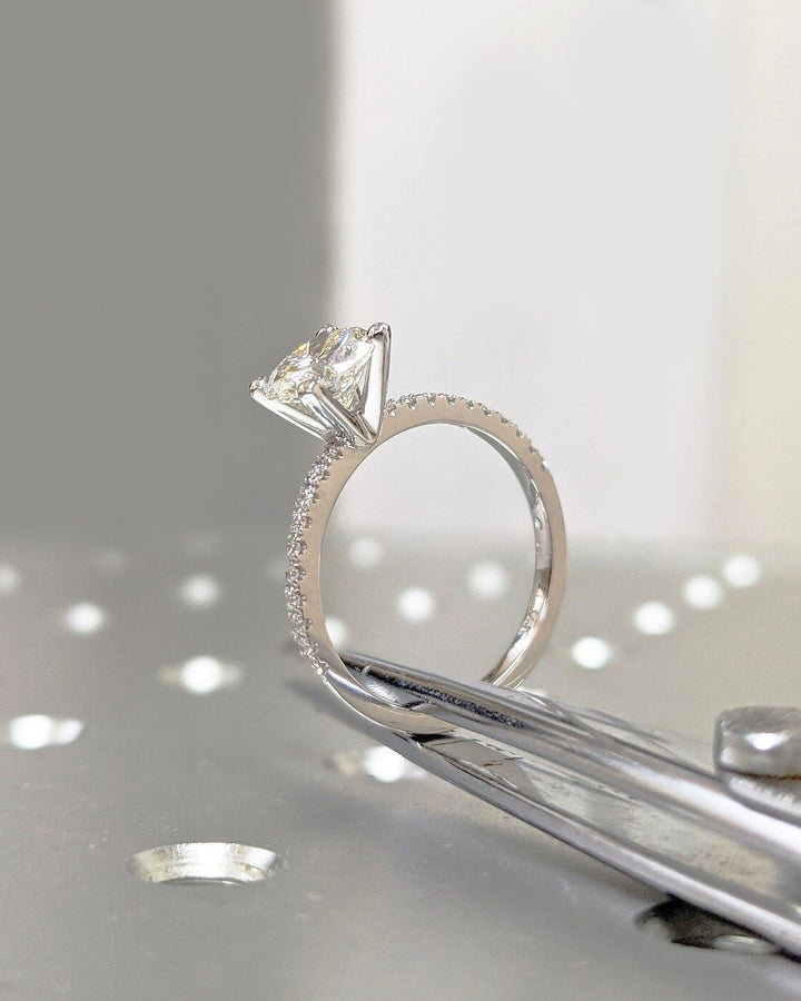 Round pave engagement ring photographed in natural light