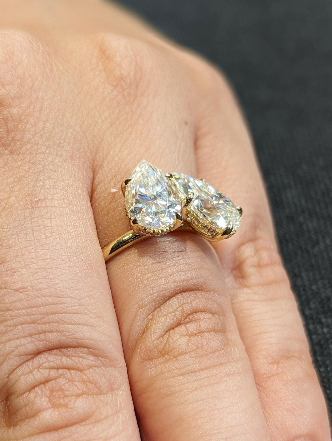 Macro shot of pear cut diamond facets in hidden halo ring setting
