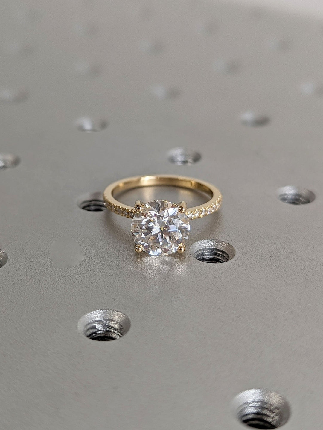 Close-up of round cut center diamond in hidden halo engagement ring
