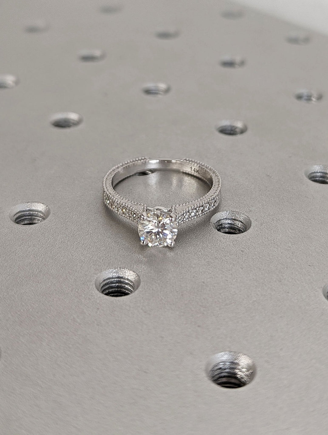 Round cut engagement ring shown with authenticity certificate