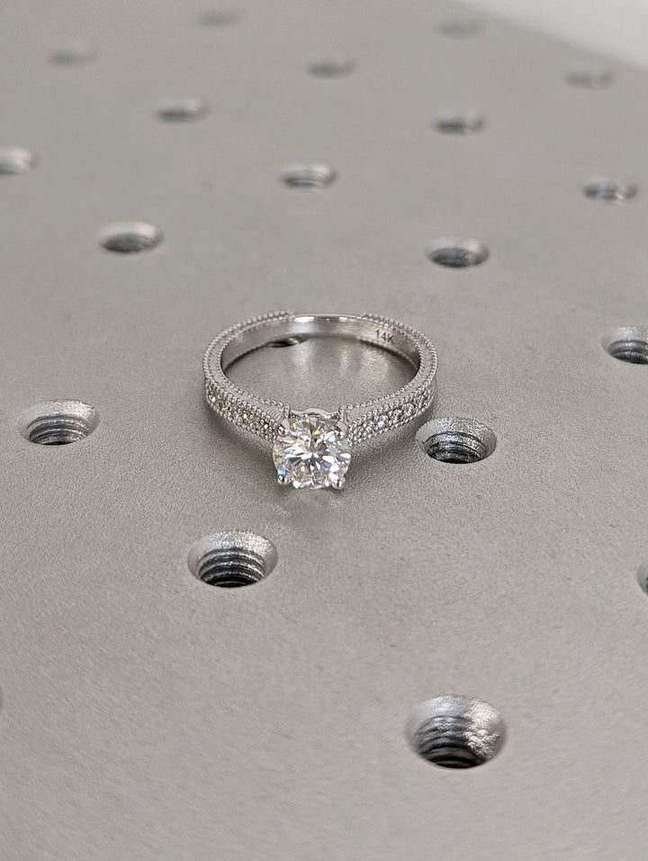 Round cut engagement ring shown with authenticity certificate