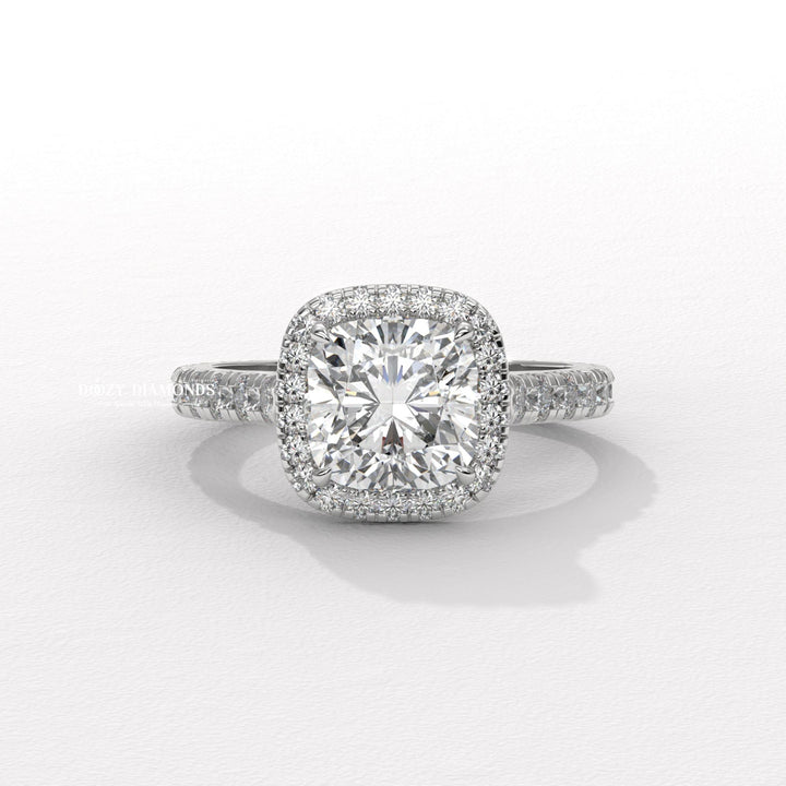 Macro shot of cushion cut diamond facets in halo ring setting