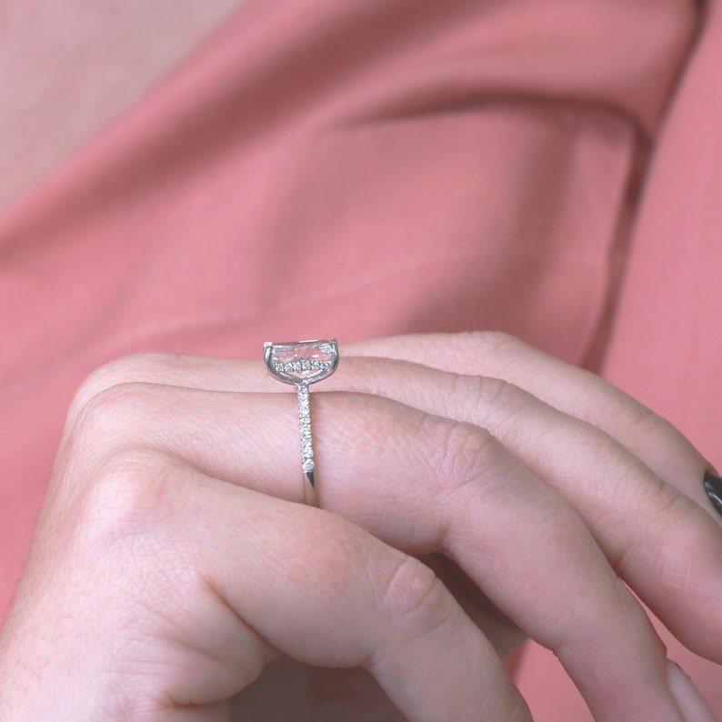 Radiant hidden halo engagement ring shown on hand for true-to-life sizing