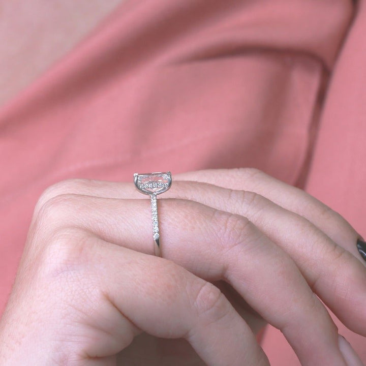 Radiant hidden halo engagement ring shown on hand for true-to-life sizing