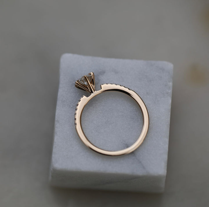 Round solitaire engagement ring photographed in natural light