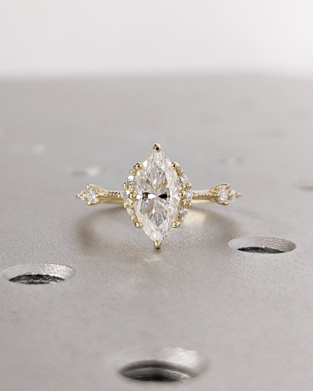 Detailed close-up of marquise cluster diamond engagement ring