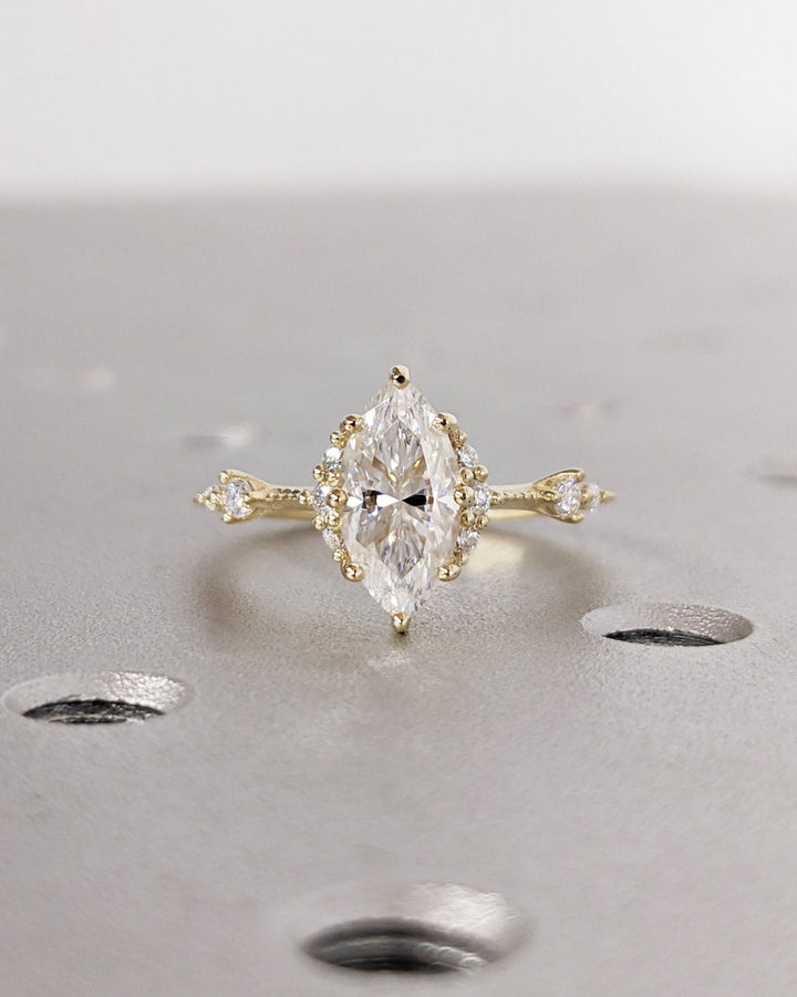 Detailed close-up of marquise cluster diamond engagement ring