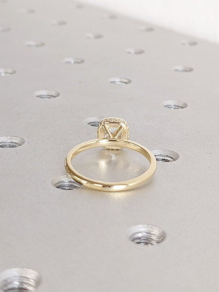 Cushion hidden halo engagement ring close-up highlighting diamond sparkle