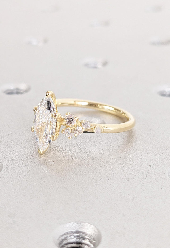 Marquise cluster engagement ring close-up highlighting diamond sparkle