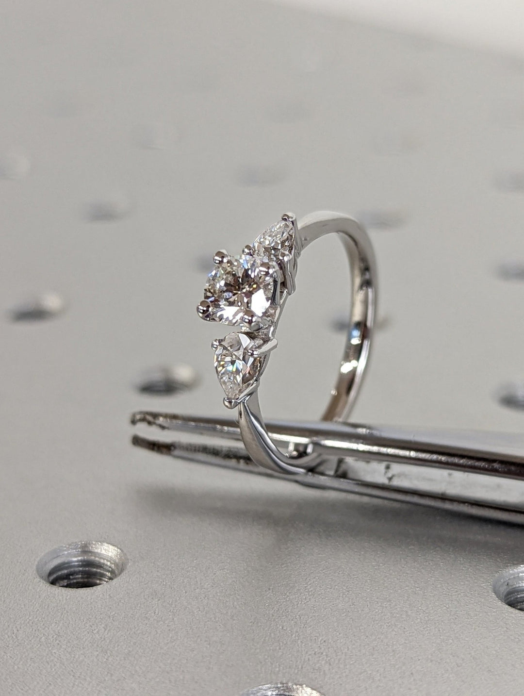 Detailed close-up of round solitaire diamond engagement ring