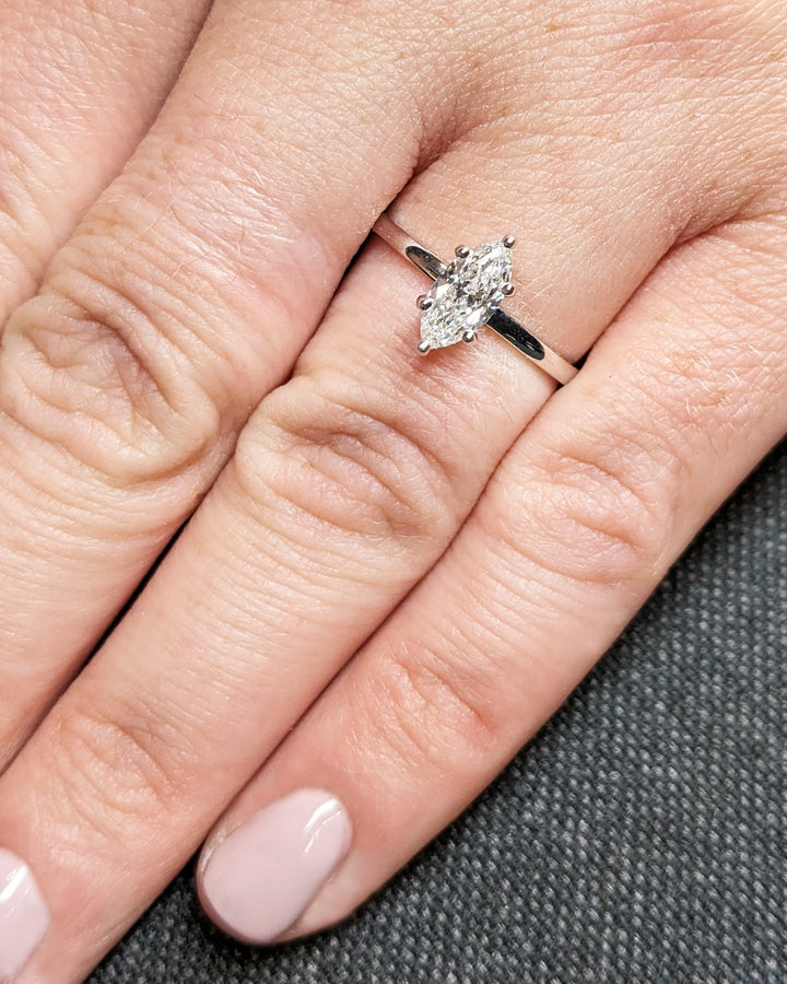 Marquise cut solitaire engagement ring shown in real-life wear