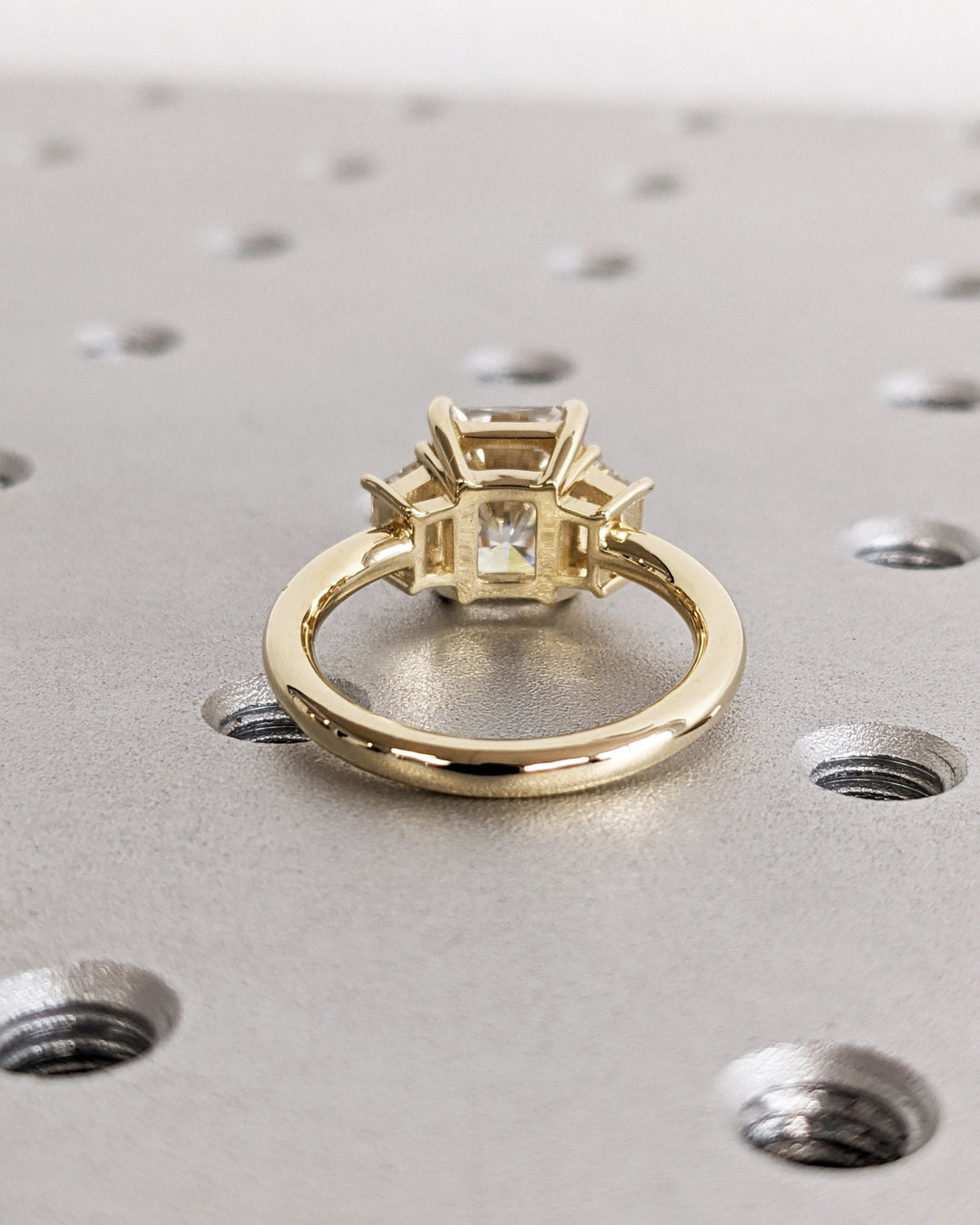 Certified radiant cut diamond featured in three stone engagement ring