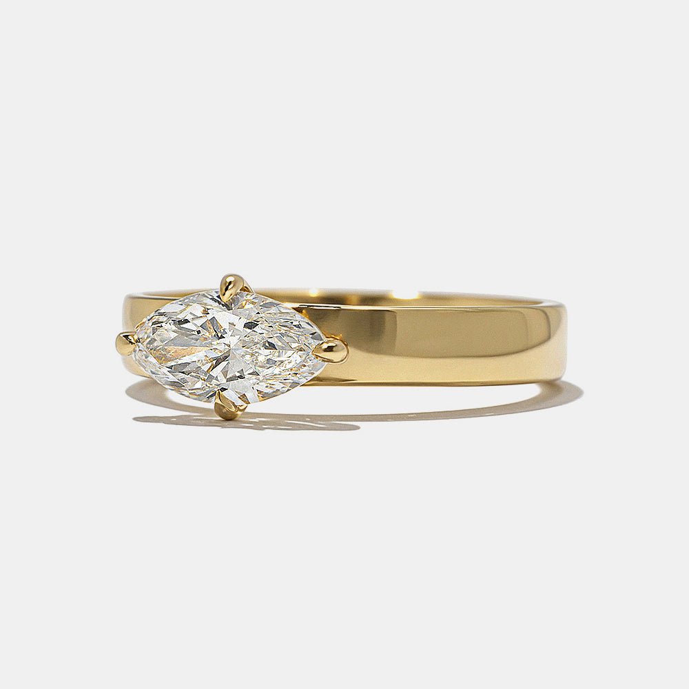 Close-up of marquise cut center diamond in east west engagement ring