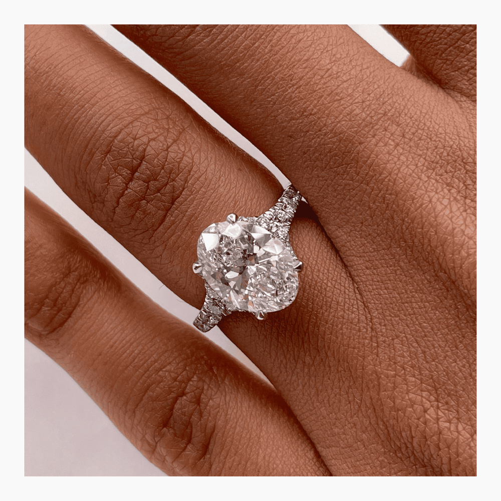 Oval cluster engagement ring finished in polished solid gold