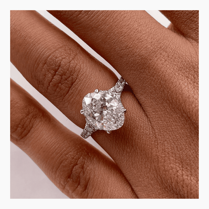 Oval cluster engagement ring finished in polished solid gold