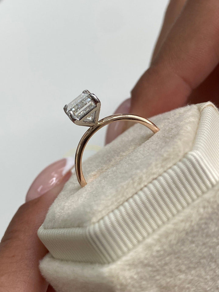 Unboxing view of emerald cut solitaire diamond engagement ring