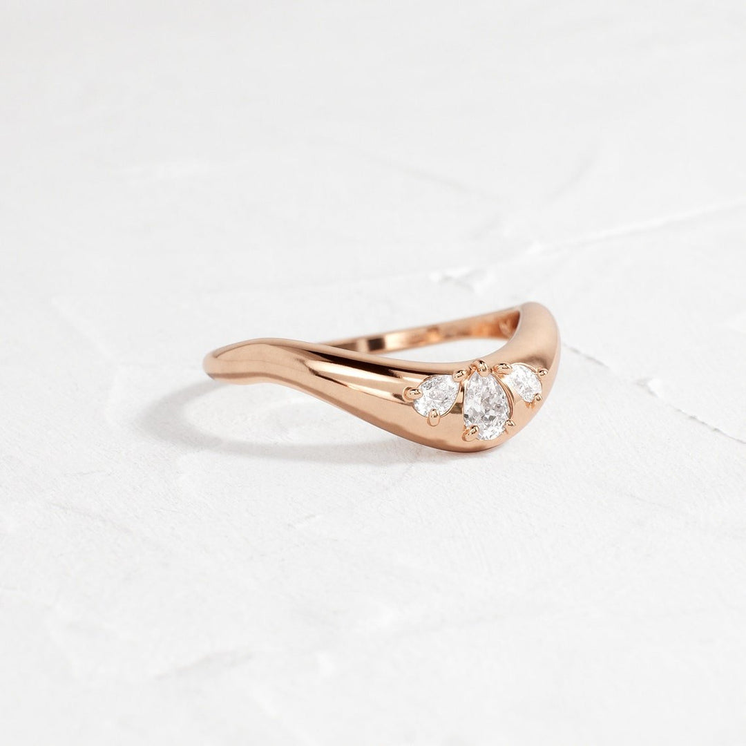 Pear diamond band stacked with engagement ring