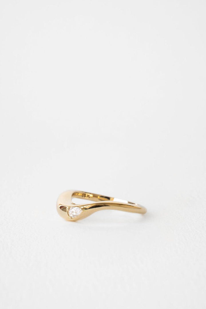 Pear diamond band stacked with engagement ring